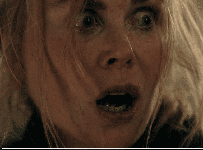 Scarpetta standing at the door in the Season 1 finale moments before someone enters