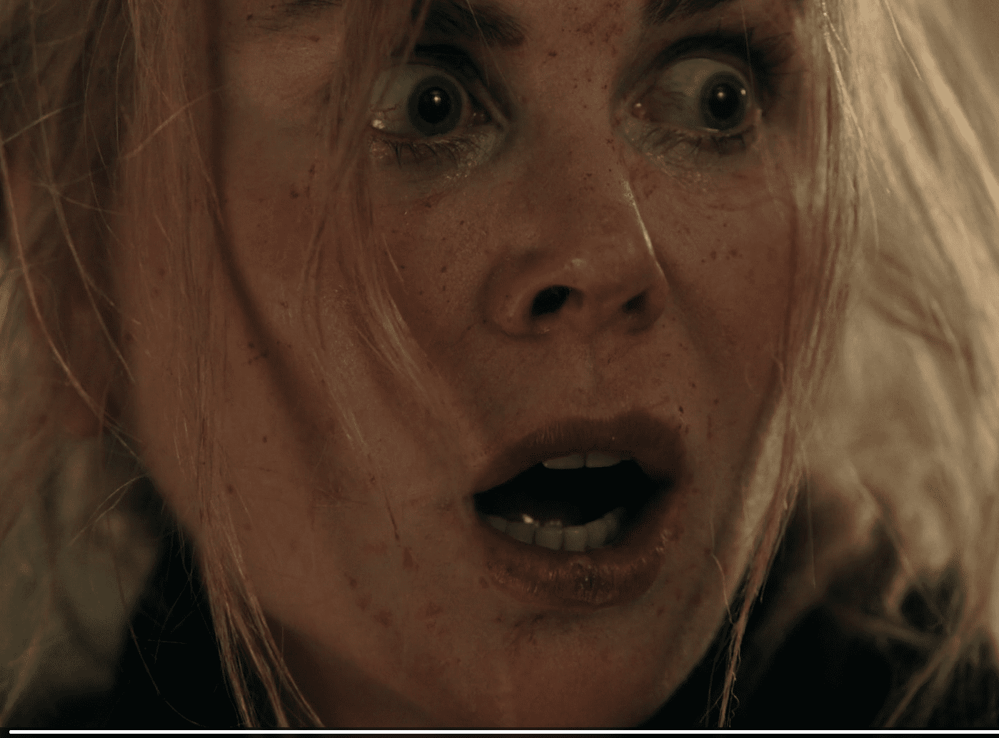 Scarpetta standing at the door in the Season 1 finale moments before someone enters