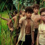 Lord of the Flies Netflix series boys on island holding spears survival scene