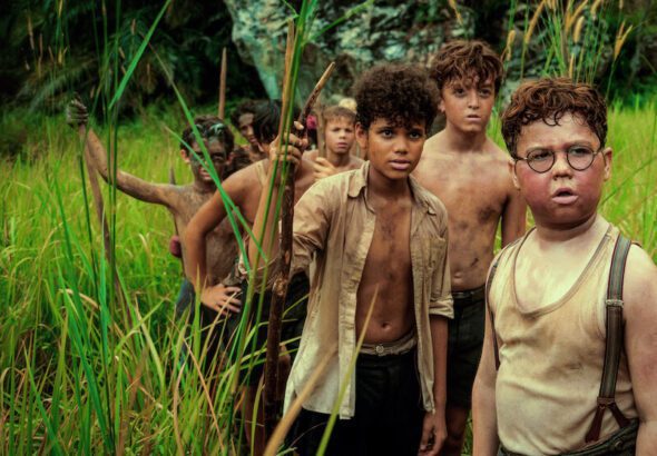 Lord of the Flies Netflix series boys on island holding spears survival scene