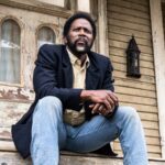 boyd-sitting-on-the-colony-house-porch-in-from-season-4