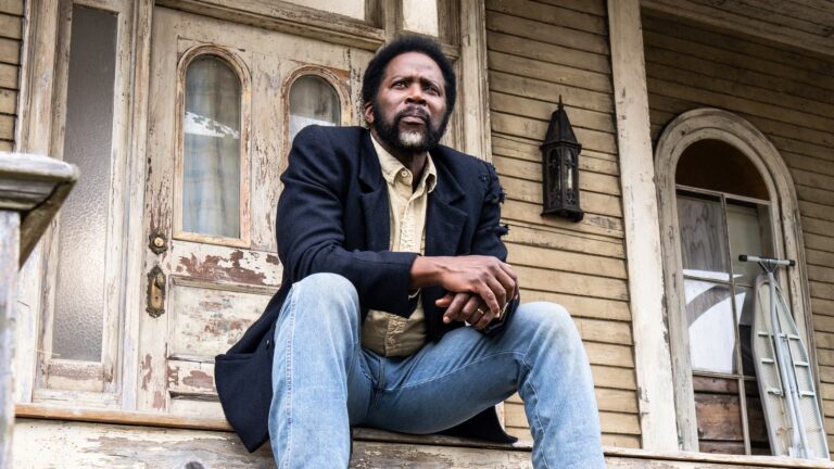 boyd-sitting-on-the-colony-house-porch-in-from-season-4