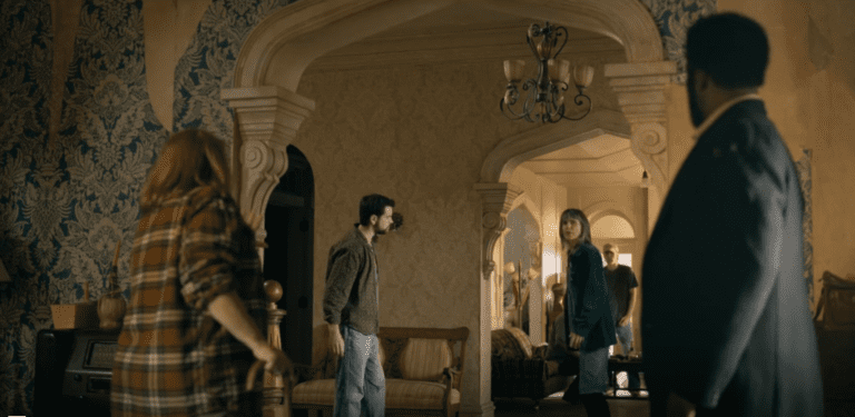 Residents stand inside Colony House during a tense moment in FROM Season 4 Episode 8.