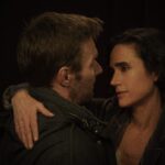 Jason Dessen and Daniela embrace as she looks into his eyes in Dark Matter.
