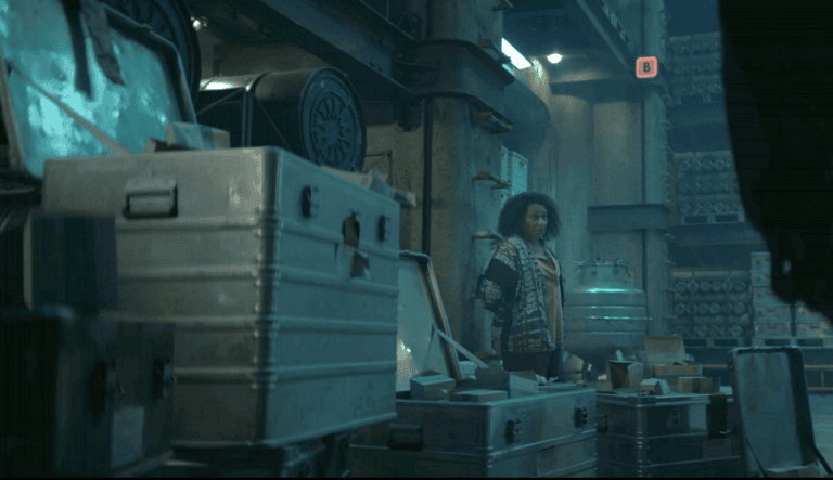 Carla standing among empty storage cases in Critical Supply in Silo Season 3 Episode 5.
