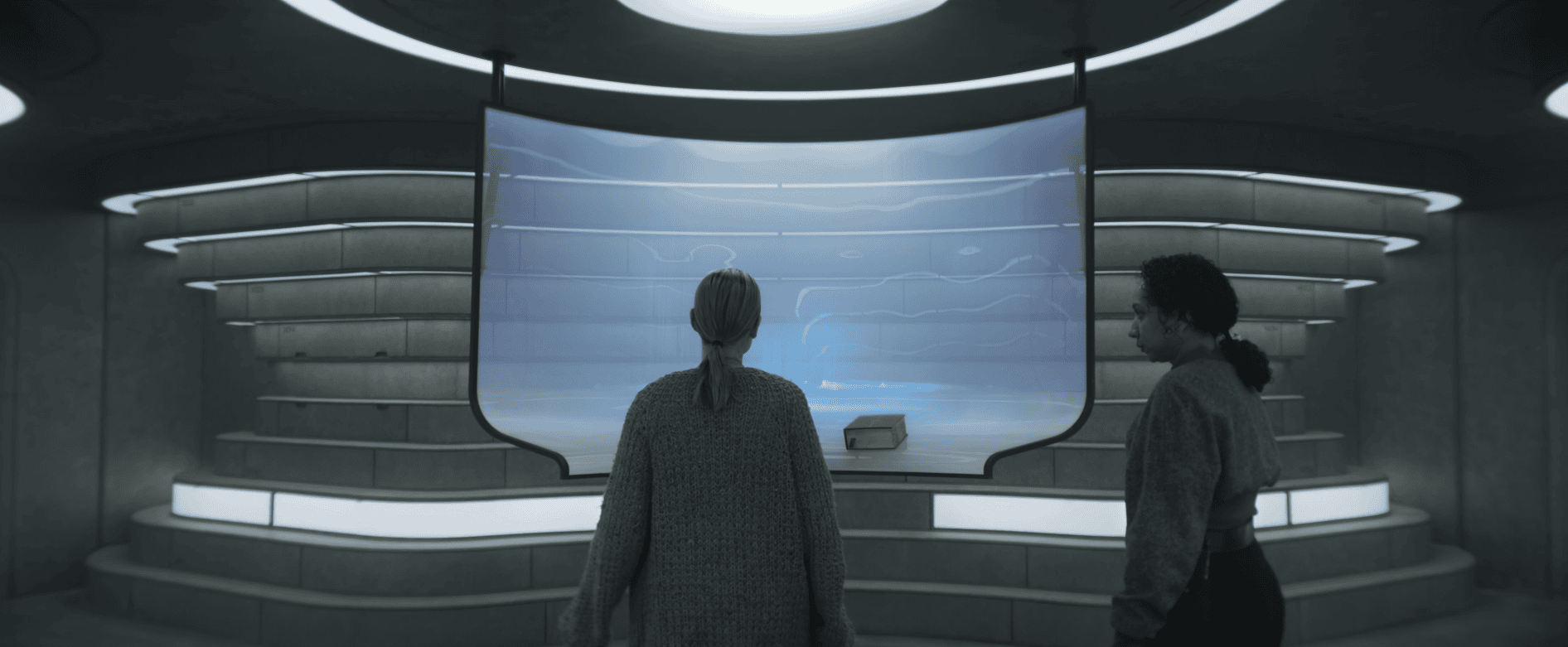 Juliette Nichols and Martha Walker examine the Silo 17 schematic in Silo Season 3 Episode 6