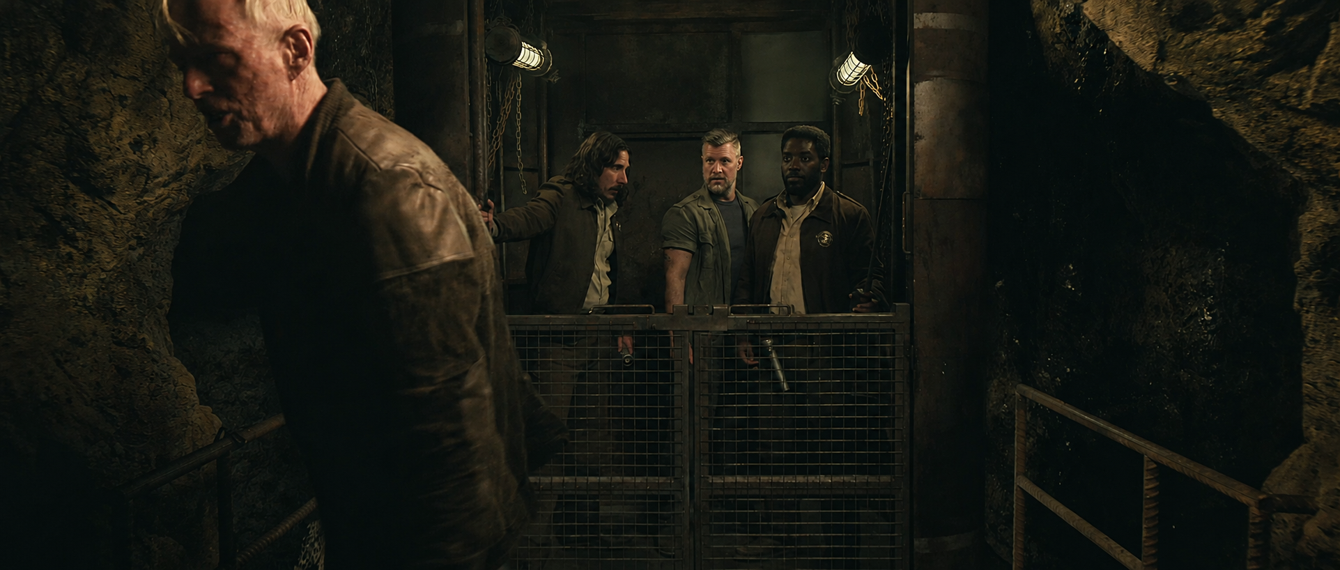 Harwood walks away as Billings and the others discover his hidden elevator beneath the Mines in Silo Season 3.