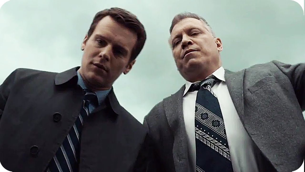 Two FBI agents from Netflix’s Mindhunter look down toward the camera in a scene from the crime drama series.