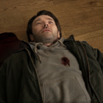A variant Jason lies wounded on a wooden floor in Dark Matter Season 2 Episode 2.