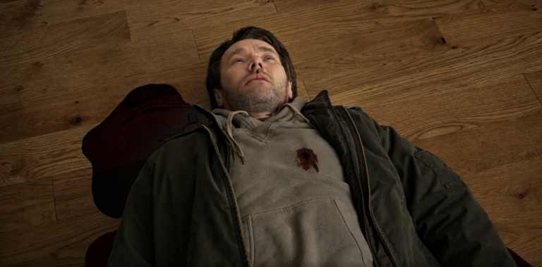 A variant Jason lies wounded on a wooden floor in Dark Matter Season 2 Episode 2.