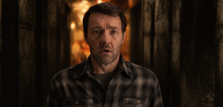 Jason Dessen standing in a dim hallway during a strange reality-shift moment in Dark Matter Season 2 Episode 3.