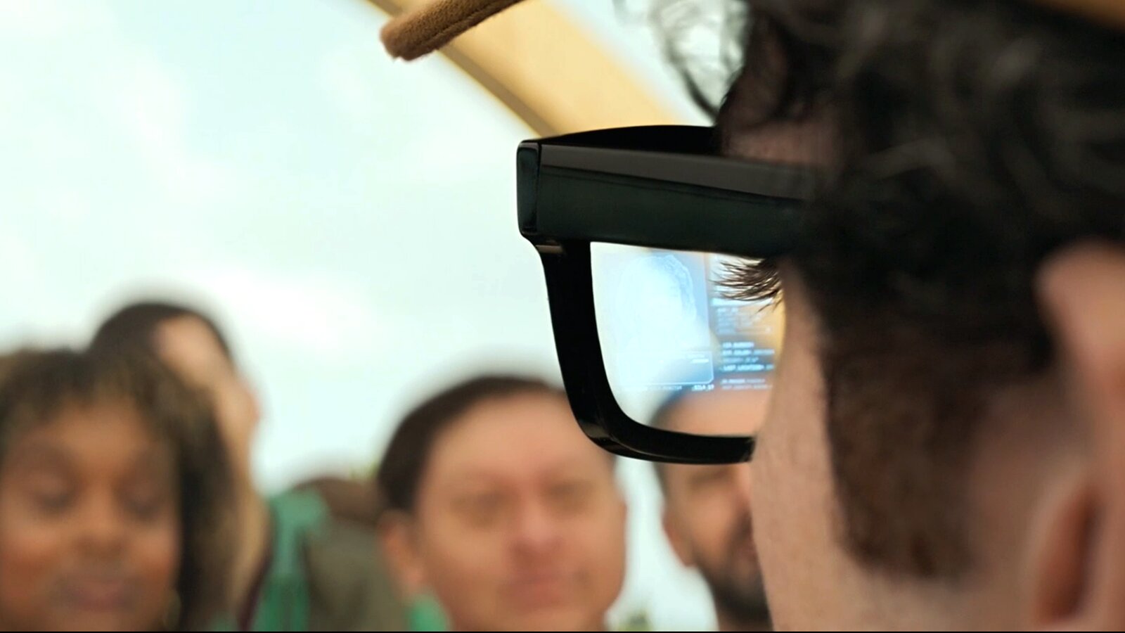 A guide checks augmented reality glasses during the Silo unveiling in Season 3 Episode 9