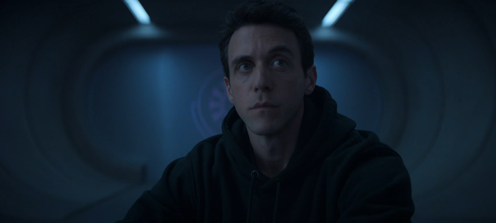 Daniel sits awake inside Silo 1 during one of his shifts in the Silo Season 3 finale